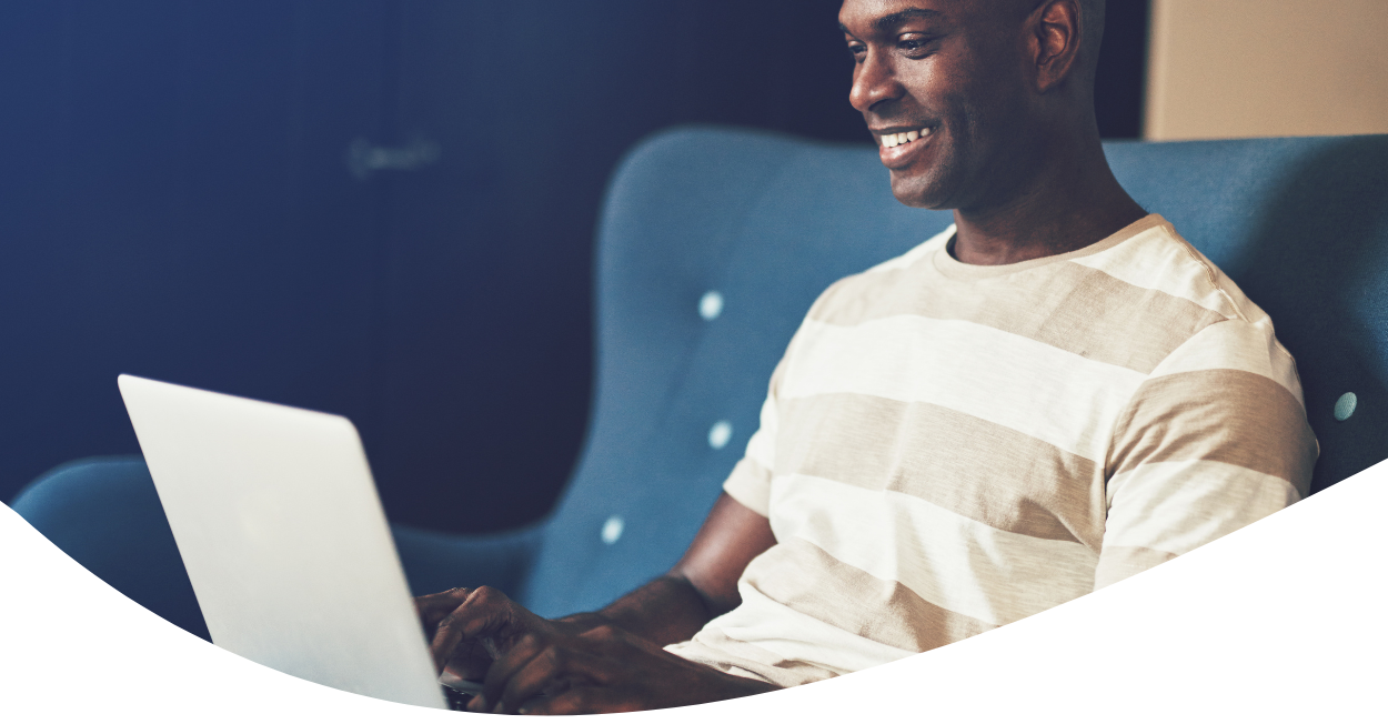 man on couch with laptop